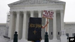 A person protests outside the Supreme Court, June 30, 2023, in Washington.