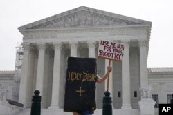 A person protests outside the Supreme Court, June 30, 2023, in Washington.