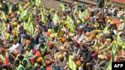 Members of the farm union Bharatiya Kisan Union (Ekta Ugrahan) block railway tracks during a protest to demand minimum crop prices at a railway station in Rajpura on Feb. 15, 2024.