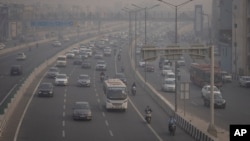 Motociclistas conducen con máscaras contra la contaminación en medio del smog en Nueva Delhi, India, el martes 7 de noviembre de 2023.