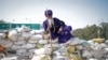 A Nihang, or Sikh warrior, rests on a makeshift barricade of sand bags at a protest site during the march toward New Delhi to push for better crop prices, at Shambhu Barrier, the border between Punjab and Haryana states, India.