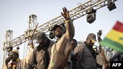 FILE- Opposition leader, Ousmane Sonko waves to supporters during an opposition meeting two days before his trial in Dakar on March 14, 2023. 