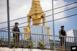 Thai police officers stand guard outside parliament during vote counting, in Bangkok, July 13, 2023.