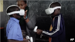 FILE - Various of students using virtual reality (VR) headsets in classroom, playing game about waste collection and waste sorting at the Mcedo Beijing School in Mathare neighborhood in Nairobi, Kenya on May 23, 2023. 