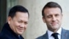 FILE — French President Emmanuel Macron, right, winks as he welcomes Cambodia's Prime Minister Hun Manet in Paris, Jan. 18, 2024. Hun Manet has enjoyed warming relations with the West during his first few months in power despite maintaining much of his father's hardline tactics.