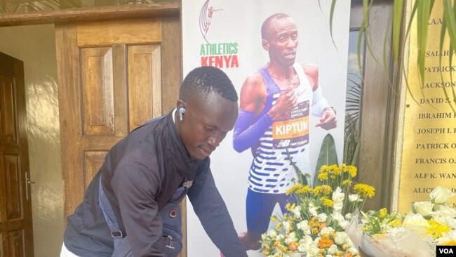 Brian Chebii, a resident of Elgeyo-Marakwet County, Kenya, signs a condolence book on Feb. 21, 2024, in Nairobi for marathon world record-holder Kelvin Kiptum, who was killed in a car crash. (Mariama Diallo/VOA)