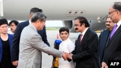 This handout photo taken July 30, 2023, and released by the Pakistan Information Department (PID) shows Pakistan's Interior Minister Rana Sanaullah (2nd R) receiving visiting Chinese Vice Premier He Lifeng (2L) upon his arrival in Islamabad.