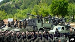 FILE - Fighters from the Lebanese militant group Hezbollah carry out a training exercise in Aaramta village in the Jezzine District, southern Lebanon, May 21, 2023. 