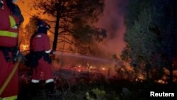 Military Emergency Unit firefighters battle flames from the Villanueva de Viver wildfire, Spain, March 23, 2023. (Military Emergency Unit/Handout via Reuters).