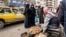 FILE - A truffle vendor speaks to customers at a market in Raqa, Syria, March 14, 2023. Fourteen truffle hunters were reportedly killed Sunday by an unexploded mine in the Raqa desert.