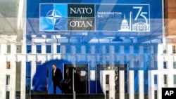 A NATO summit attendee walks through the Walter E. Washington Convention Center in Washington, on Tuesday, July 9, 2024. (AP Photo/Noah Berger)