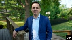 KCCI-TV chief meteorologist Chris Gloninger stands outside his home June 27, 2023, in West Des Moines, Iowa.