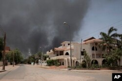 FILE - Smoke is seen rising from a neighborhood in Khartoum, Apr. 15, 2023. Fierce clashes between Sudan’s military and the country’s paramilitary erupted in the capital.