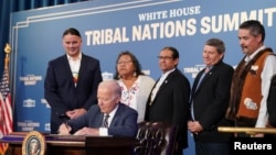 U.S. President Joe Biden signs an executive order to usher in the next era of tribal self-determination during the White House Tribal Nations Summit at the Department of the Interior in Washington, Dec. 6, 2023.