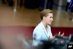 Denmark's Prime Minister Mette Frederiksen speaks with the media as she arrives for an EU summit at the European Council building in Brussels, Thursday, June 29, 2023.
