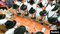 Visitors celebrate the world&#39;s largest beer festival, the 188th Oktoberfest, in Munich, Germany.