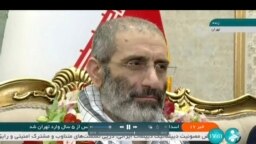 FILE- Frame grab from video released May 26, 2023, by IRINN of Assadollah Assadi, an Iranian released in a prisoner swap with Belgium, at Mehrabad airport in Tehran, Iran.
