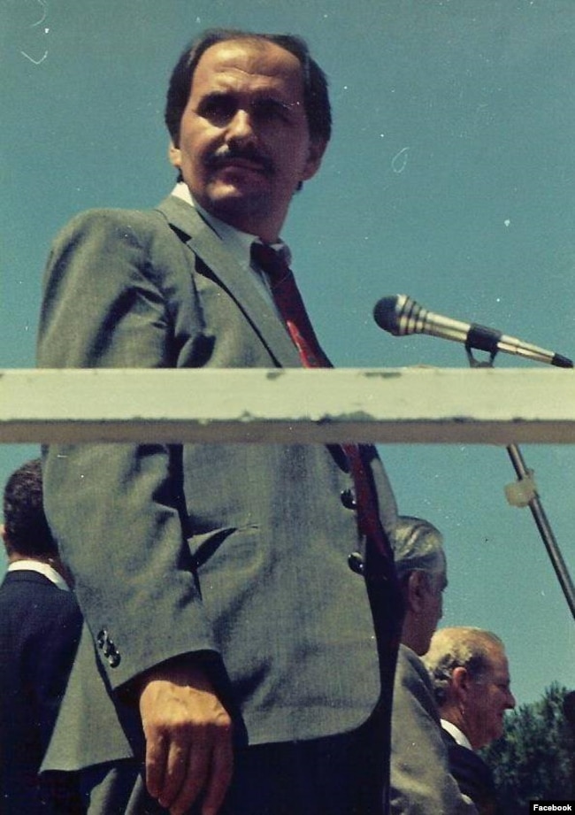 Elez Biberaj serves as a translator for then-U.S. Secretary of State James Baker before a rally of some 300,000 people on June 22, 1991, as Baker, bottom right, congratulated them on throwing off decades of communist rule.