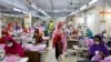 FILE - Women work in a garment factory in Dhaka, Bangladesh, May 3, 2020. Most garment factories in Bangladesh reopened on Tuesday after being closed recently because of widespread protests.