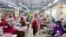 FILE - Women work in a garment factory, as factories reopened after the government has eased the restrictions amid concerns over the COVID-19 outbreak in Dhaka, Bangladesh, May 3, 2020. 