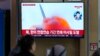 FILE - A TV screen shows a file photo of a North Korean missile launch during a news program, at the Seoul Railway Station in Seoul, South Korea, March 22, 2023. 