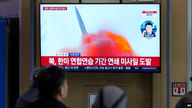 FILE - A TV screen shows a file photo of a North Korean missile launch during a news program, at the Seoul Railway Station in Seoul, South Korea, March 22, 2023.