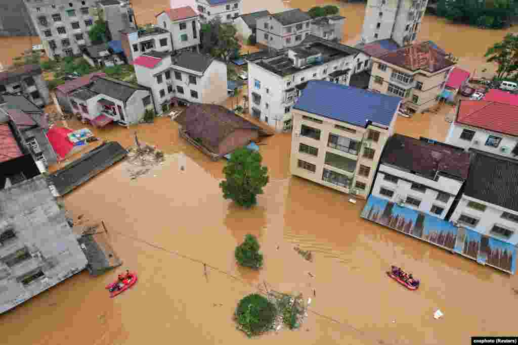 A drone view shows flooded buildings following heavy rainfall in Pingjiang county of Yueyang, Hunan province, China.