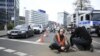 Police remove an activist of the environmental group 'Last Generation' (Letzte Generation) sitting on the ground to cause a traffic jam near Berlin's Ernst-Reuter-Platz central place during a climate action in Berlin, Germany, April 24, 2023.