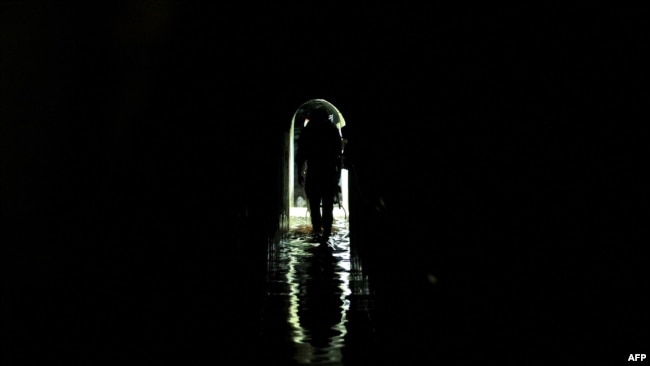 This photo, taken during a Feb. 8, 2024, media tour organized by the Israeli military, shows an Israeli soldier inside a tunnel that the army claims is a 