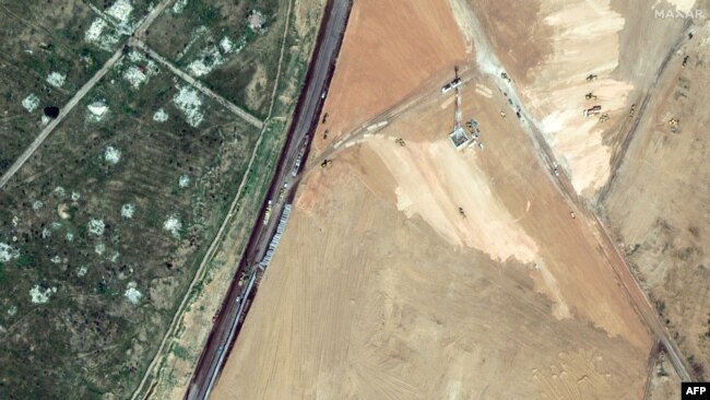 This handout satellite picture taken and released by Maxar Technologies on Feb. 15, 2024 shows machinery building a wall along the Egypt-Gaza Strip border in Rafah, Egypt. (©2024 Maxar Technologies)