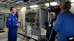 Marco Sieber of Switzerland talks to the Associated Press in a Columbus trainings module after the graduation ceremony at the European Astronaut Centre in Cologne, Germany, April 22, 2024.