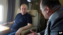 Russian President Vladimir Putin, left, listens to Dagestan leader Sergei Melikov during a working visit to Dagestan Republic, in Derbent, Russia, June 28, 2023. (Kremlin Pool Photo via AP)