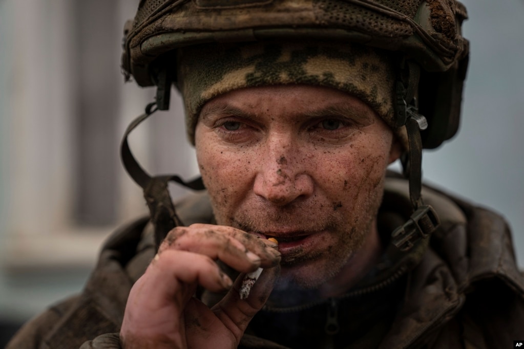 Un soldado ucraniano que acaba de regresar de las trincheras en Bájmut fuma un cigarrillo en Chasiv Yar, Ucrania, el 8 de marzo de 2023. (AP Foto/Evgeniy Maloletka).