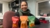 Patrice Cunningham, founder and CEO of Tae-Gu Kimchi, poses in her Washington office with three bags of the kimchi she makes and distributes with her mother, Jan. 24, 2024.