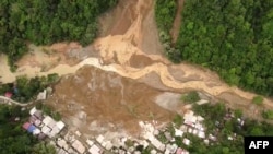 This screengrab from AFPTV aerial video footage taken on Feb. 7, 2024 shows the site of a landslide in Davao de Oro province on Mindanao island in the southern Philippines. 