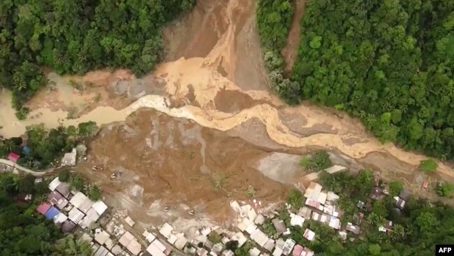 This screengrab from AFPTV aerial video footage taken on Feb. 7, 2024 shows the site of a landslide in Davao de Oro province on Mindanao island in the southern Philippines.