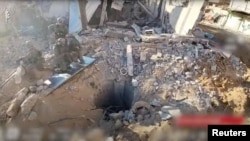 An opening to a tunnel that, according to Israel's military, was used by Palestinian militants under Shifa Hospital in the Gaza Strip as seen in this screen grab taken from a handout video released by the Israel Defense Forces, Nov. 19, 2023. 