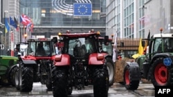 Tractors are stationed in front of the European Parliament during a protest called by farmers' organizations in response to the European Agriculture Council, in Brussels, on Feb. 26, 2024.