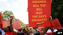 FILE - Uganda's queer activist Papa De raises a fist outside the Uganda High Commission during a picket against the countrys anti-homosexuality bill in Pretoria, South Africa, on April 4, 2023.
