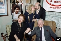 FILE - Sally Struthers plants a kiss on the cheek of Rob Reiner, right, as Carroll O'Connor and Jean Stapleton hold hands during a reunion of the cast of "All in the Family," in Beverly Hills, California, Feb. 12, 1991.