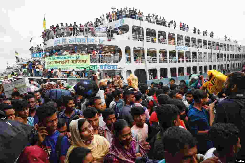 Thousands of people rush to get on board overcrowded ferries at the Sadarghat Ferry Terminal as they leave the capital city to celebrate Eid-al Adha with their families, in Dhaka, Bangladesh, June 27, 2023.