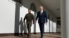 FILES - U.S. President Joe Biden walks with Ukraine's President Volodymyr Zelensky through the colonnade of the White House, in Washington, DC on December 21, 2022. 