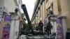 FILE - Fighters of Wagner private mercenary group stand on a tank outside a local circus near the headquarters of the Southern Military District in the city of Rostov-on-Don, Russia, June 24, 2023.