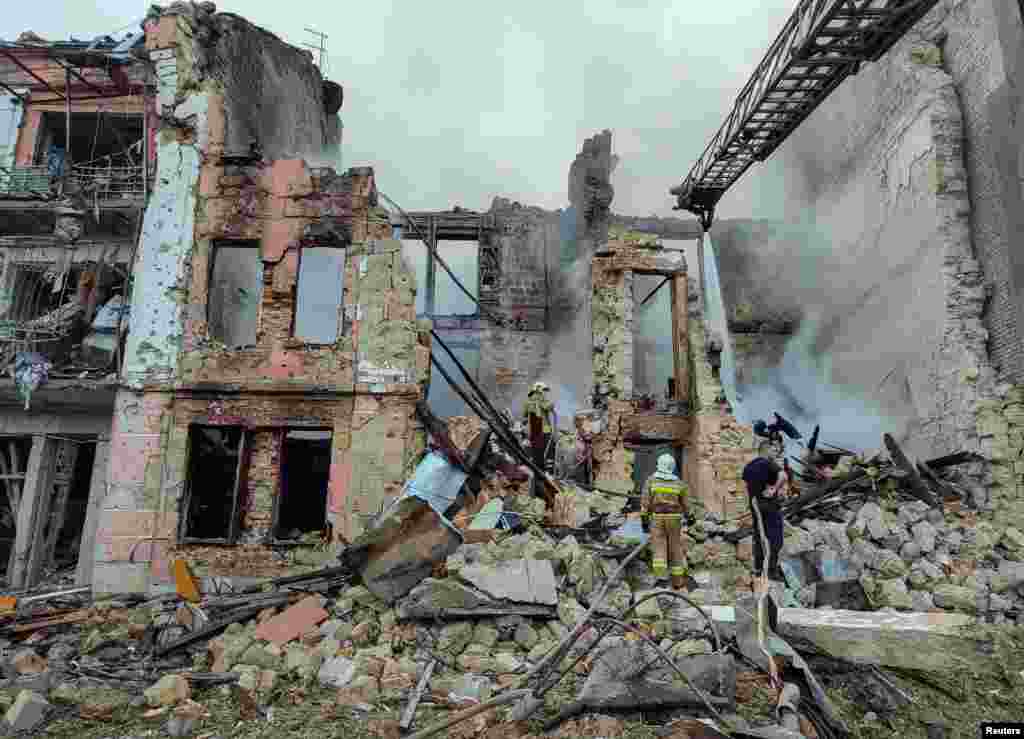 Rescuers work at the site of a residential building heavily damaged by a Russian missile attack in Mykolaiv, Ukraine. 