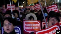 Doctors rally against the government's medical policy near the presidential office in Seoul, South Korea, Feb. 22, 2024. 
