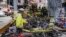 FILE - A biker stops to look at a pile of e-bikes in the aftermath of a fire in Chinatown, which authorities say started at an e-bike shop and spread to upper-floor apartments, Tuesday June 20, 2023, in New York.