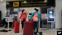 FILE - Chinese tourists arrive at Chiang Mai international airport in Chiang Mai province, northern Thailand, Jan. 23, 2023. Numbers of Chinese tourists traveling to Thailand recently have slumped. Some blame a movie highlighting how visitors are scammed in Southeast Asia.