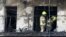 Firefighters remove a charred body inside a burned block building in Valencia, Spain, Feb. 23, 2024. 