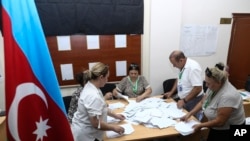 Members of an election commission count ballots at a polling station after a snap election in the Milli Mejlis parliament in Baku, Azerbaijan, Sept. 1, 2024.