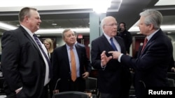 FILE - Sen. Jon Tester of Montana, Sen. Dick Durbin of Illinois, then-Sen. Pat Leahy of Vermont and Sen. John Hoeven of North Dakota talk as lawmakers gather to negotiate over a U.S. government shutdown and border security, in Washington, Jan. 30, 2019.